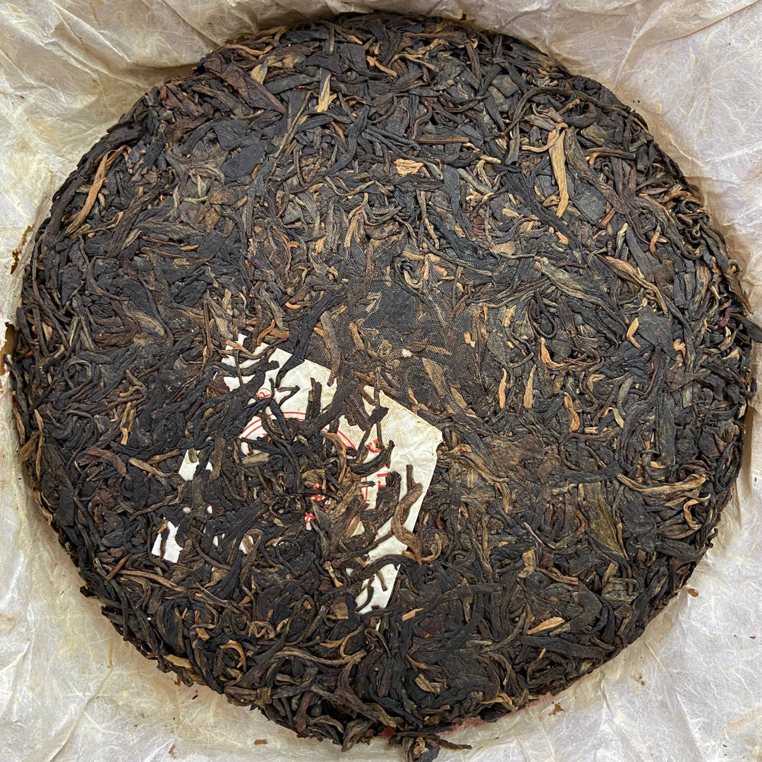 2004 LiMing "Cha Wang - Qiao Mu Ye Sheng - Ban Zhang & Bu Lang & Nan Nuo" (King Tea - Arbor Wild - Banzhang & Bulang & Nannuo) Cake 400g Puerh Sheng Cha Raw Tea