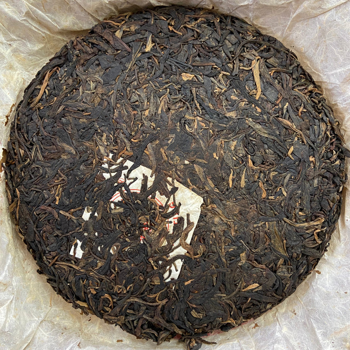 2004 LiMing "Cha Wang - Qiao Mu Ye Sheng - Ban Zhang & Bu Lang & Nan Nuo" (King Tea - Arbor Wild - Banzhang & Bulang & Nannuo) Cake 400g Puerh Sheng Cha Raw Tea
