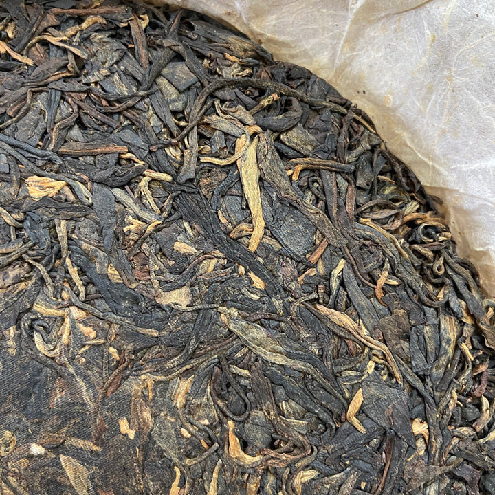 2004 LiMing "Cha Wang - Qiao Mu Ye Sheng - Ban Zhang & Bu Lang & Nan Nuo" (King Tea - Arbor Wild - Banzhang & Bulang & Nannuo) Cake 400g Puerh Sheng Cha Raw Tea