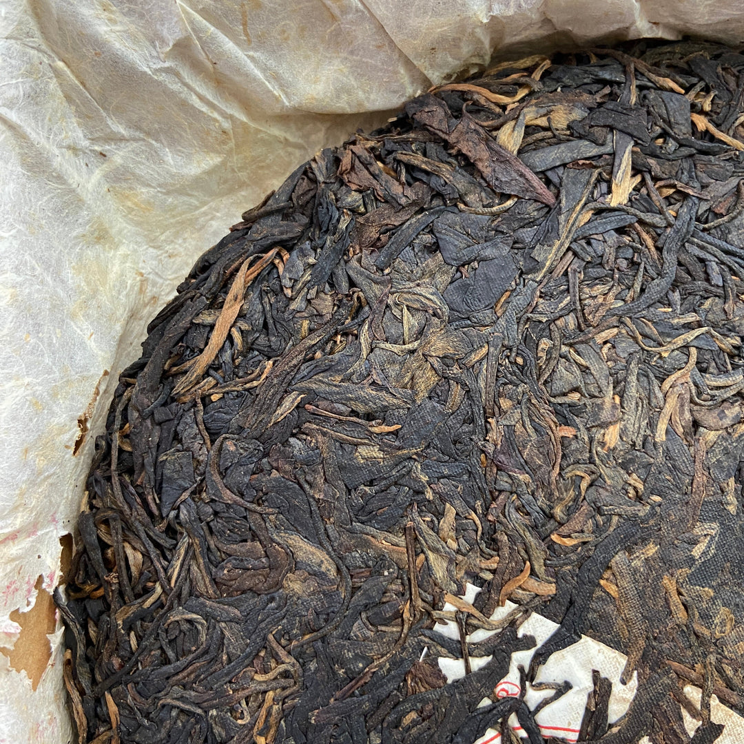 2004 LiMing "Cha Wang - Qiao Mu Ye Sheng - Ban Zhang & Bu Lang & Nan Nuo" (King Tea - Arbor Wild - Banzhang & Bulang & Nannuo) Cake 400g Puerh Sheng Cha Raw Tea