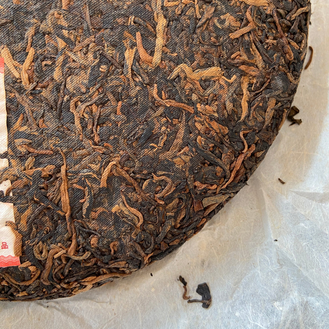 2006 LiMing "Nv Er Gong Bing - Bu Lang Shan - Qiao Mu Old Tree" (Girl's Tribute Cake - Bulang Mountain - Arbor Old Tree) 250g Puerh Ripe Tea Shou Cha